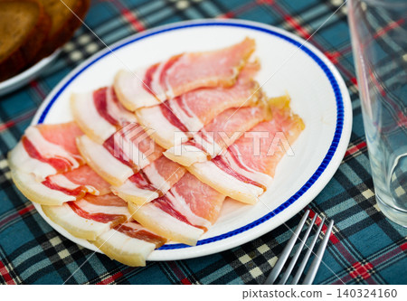 Salted pork belly bacon slices on plate Salted pork belly bacon slices on plate 140324160