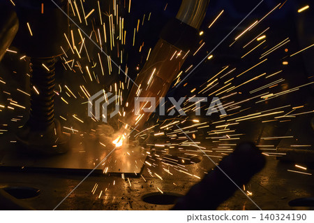 Close-up of sparkling light and bright sparks during an industrial high-precision laser welding process. 140324190