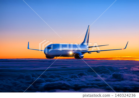 Passenger plane flies in the sunset sky Passenger plane flies in the sunset sky 140324236