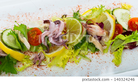 Deliciously salad of boiled squids with lime, lettuce leaves Deliciously salad of boiled squids with lime, lettuce leaves 140324246