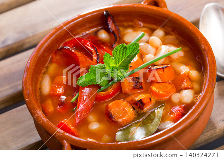 Bean's soup of broth cooked with boiled carrots, pepper and greens Bean's soup of broth cooked with boiled carrots, pepper and greens 140324271