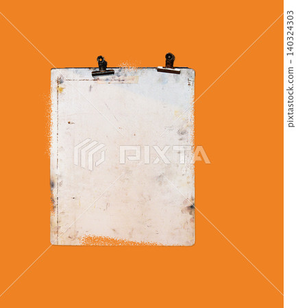 Old, weathered clipboard with dark clips centered against a vivid orange background. Old, weathered clipboard with dark clips centered against a vivid orange background. 140324303