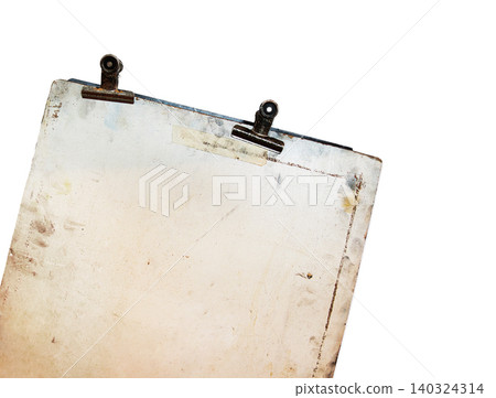 Vintage sketch board with two old metal clips at the top, showing rust, stains, and age marks on a discolored surface. isolated on white background. 140324314