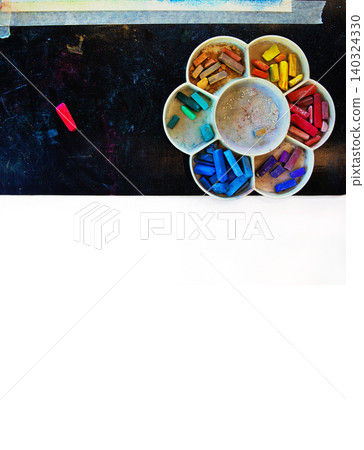 Top view of colorful pastel chalks arranged in a flower shaped palette, placed on a half black and half white background and single red pastel stick on the side Top view of colorful pastel chalks arranged in a flower shaped palette, placed on a half black and half white background and single red pastel stick on the side 140324330