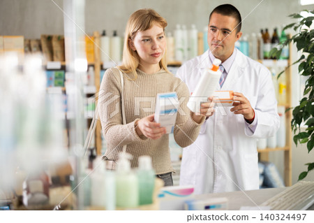 woman chooses a cream against the background of a pharmacist 140324497