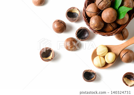 Top View of Macadamia Nuts and Kernels with Wooden Spoon on White Background 140324731