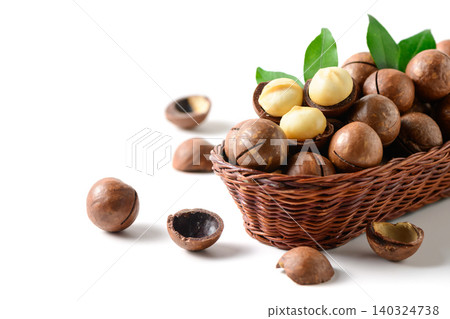 Macadamia Nuts and Kernels in Wicker Basket Isolated on White Background Macadamia Nuts and Kernels in Wicker Basket Isolated on White Background 140324738
