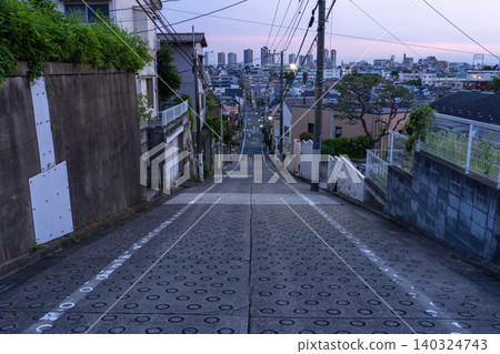 A sloping residential street in Higashi-Yukigaya, Ota Ward, Tokyo, and a night view of the tower apartments in Musashi-Kosugi. A sloping residential street in Higashi-Yukigaya, Ota Ward, Tokyo, and a night view of the tower apartments in Musashi-Kosugi. 140324743