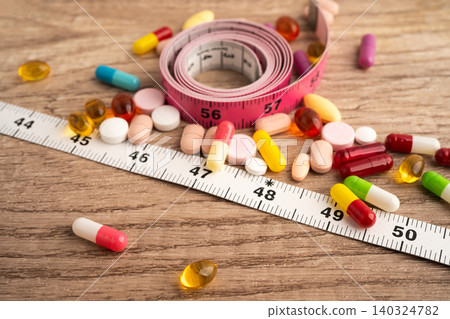 Measuring tape and tablet drug medical for diet. Measuring tape and tablet drug medical for diet. 140324782