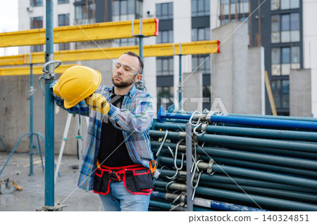 Construction worker wearing hard hat and safety glasses Construction worker wearing hard hat and safety glasses 140324851