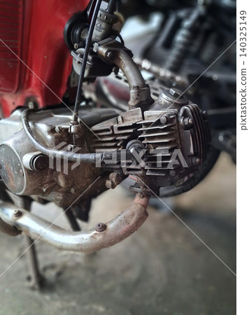 Close-Up Of Rusty Vintage Motorcycle Engine And Exhaust Showing Grime And Mechanical Detail 140325149