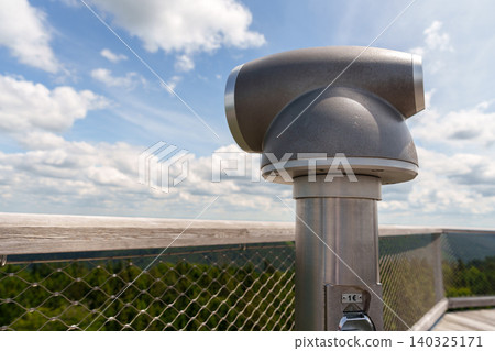 Public viewing binoculars on observation deck with landscape view 140325171