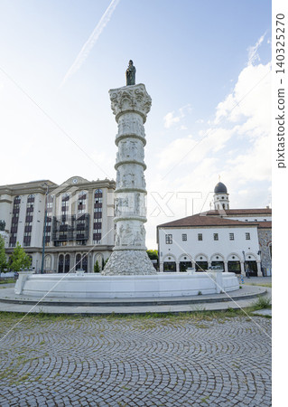 the old column with the statue of the Madonna on top in the center of the Holy Mother of God Square in Skopje, North Macedonia the old column with the statue of the Madonna on top in the center of the Holy Mother of God Square in Skopje, North Macedonia 140325270