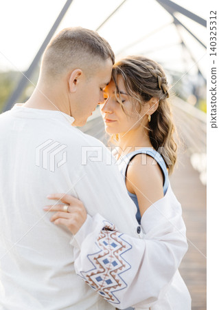 A Loving Couple Embraces Each Other Tenderly on a Sleek and Contemporary Bridge, Symbolizing Their Deep Connection and Affection A Loving Couple Embraces Each Other Tenderly on a Sleek and Contemporary Bridge, Symbolizing Their Deep Connection and Affection 140325312