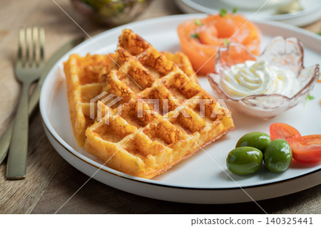 Crunchy waffle fries with sour cream dip served in a basket Crunchy waffle fries with sour cream dip served in a basket 140325441