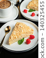 Sliced Napoleon cake on a white wooden table. Classic dessert 140325455