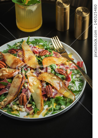 Salad with Pear, Arugula, Jamon, Blue Cheese and Blueberry, Delicious Fresh Salad Appetizer on Bright Background 140325460