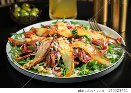 Salad with Pear, Arugula, Jamon, Blue Cheese and Blueberry, Delicious Fresh Salad Appetizer on Bright Background Salad with Pear, Arugula, Jamon, Blue Cheese and Blueberry, Delicious Fresh Salad Appetizer on Bright Background 140325461