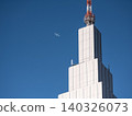 Airplanes flying over buildings 140326073