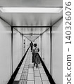 Woman walking through an underground passage 140326076