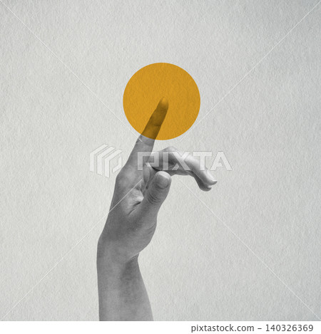 Hand touching yellow circle on gray background Hand touching yellow circle on gray background 140326369