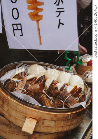 Street food in Kobe Chinatown (Nankinmachi): Rice dumplings and meat buns in a large steamer. 140326417