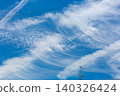 Contrails in the sky during the rainy season; blue sky and clouds. 140326424