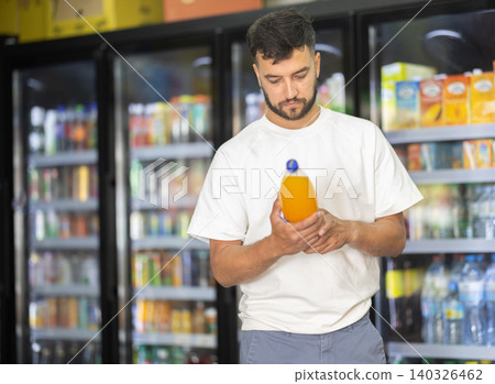 Buyer view assortment, man choose non-alcoholic drink Buyer view assortment, man choose non-alcoholic drink 140326462