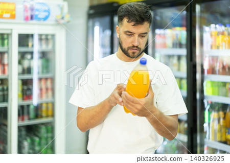 Buyer view assortment, man choose non-alcoholic drink Buyer view assortment, man choose non-alcoholic drink 140326925