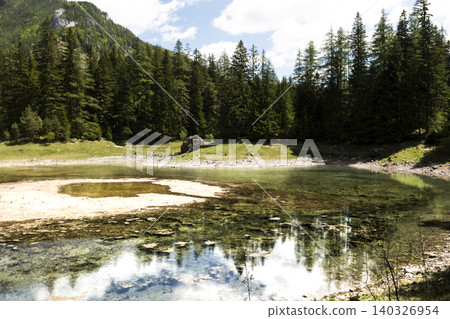 Seasonal emerald alpine lake Gruner See in Styria, Austria, highlighting fragile alpine habitats under environmental stress Seasonal emerald alpine lake Gruner See in Styria, Austria, highlighting fragile alpine habitats under environmental stress 140326954