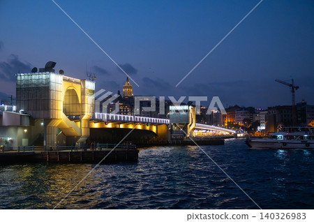 Istanbul, Turkiye at Dusk: Illuminated Bridge and Cityscape Refl Istanbul, Turkiye at Dusk: Illuminated Bridge and Cityscape Refl 140326983