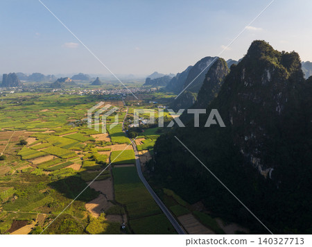 Aerial View of Lush Green Fields and Karst Mountains in Guangxi, China Aerial View of Lush Green Fields and Karst Mountains in Guangxi, China 140327713