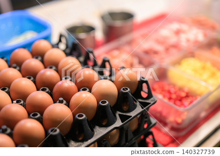 Stacks of fresh brown eggs in trays at a food stall Stacks of fresh brown eggs in trays at a food stall 140327739