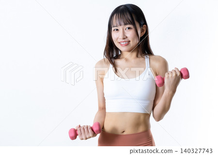 A woman lifting dumbbells to work out; dumbbell curls; female weightlifter; front view; cropped up. A woman lifting dumbbells to work out; dumbbell curls; female weightlifter; front view; cropped up. 140327743