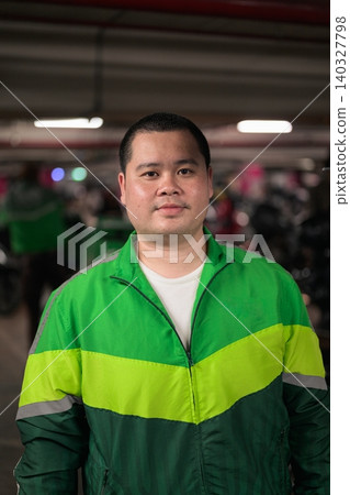 Portrait of Thai delivery man from Isan in motorcycle parking garage Portrait of Thai delivery man from Isan in motorcycle parking garage 140327798
