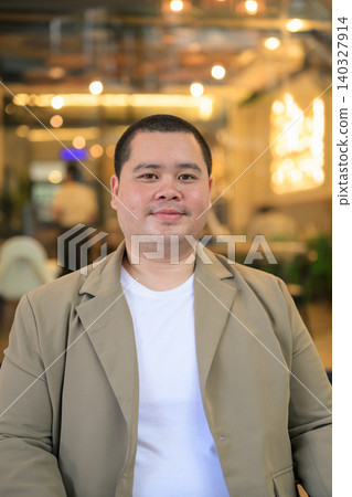 Smiling plus size Isan Thai businessman at modern restaurant vertical Smiling plus size Isan Thai businessman at modern restaurant vertical 140327914