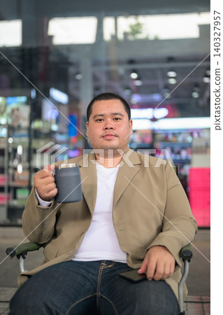 Plus size Isan Thai businessman looking at camera at a night cafe Plus size Isan Thai businessman looking at camera at a night cafe 140327957