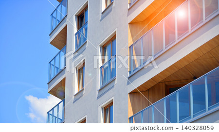 View of modern residential building with glass balconies and bright facade. Contemporary apartment building in european city. Concept of urban living and modern architecture. View of modern residential building with glass balconies and bright facade. Contemporary apartment building in european city. Concept of urban living and modern architecture. 140328059