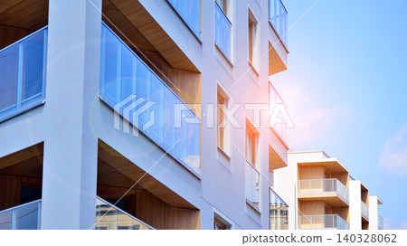 View of modern residential building with glass balconies and bright facade. Contemporary apartment building in european city. Concept of urban living and modern architecture. View of modern residential building with glass balconies and bright facade. Contemporary apartment building in european city. Concept of urban living and modern architecture. 140328062