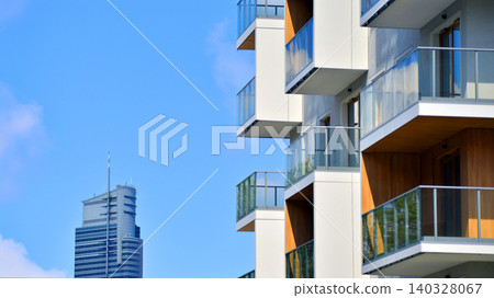 View of modern residential building with glass balconies and bright facade. Contemporary apartment building in european city. Concept of urban living and modern architecture. View of modern residential building with glass balconies and bright facade. Contemporary apartment building in european city. Concept of urban living and modern architecture. 140328067