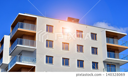 View of modern residential building with glass balconies and bright facade. Contemporary apartment building in european city. Concept of urban living and modern architecture. View of modern residential building with glass balconies and bright facade. Contemporary apartment building in european city. Concept of urban living and modern architecture. 140328069