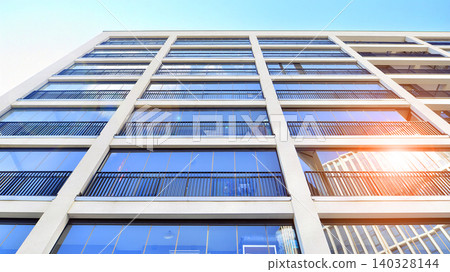 View of modern residential building with glass balconies and bright facade. Contemporary apartment building in european city. Concept of urban living and modern architecture. View of modern residential building with glass balconies and bright facade. Contemporary apartment building in european city. Concept of urban living and modern architecture. 140328144
