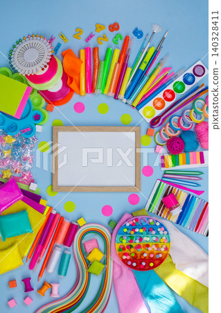 Multicolored craft supplies with copyspace. Craft supplies for creative handmade. Empty picture frame mock up. Multicolored craft supplies with copyspace. Craft supplies for creative handmade. Empty picture frame mock up. 140328411