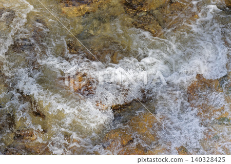 Directly above view of bright flowing water of the river 140328425