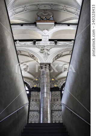 Interior church architecture with pipe organ and ornate stucco 140328433
