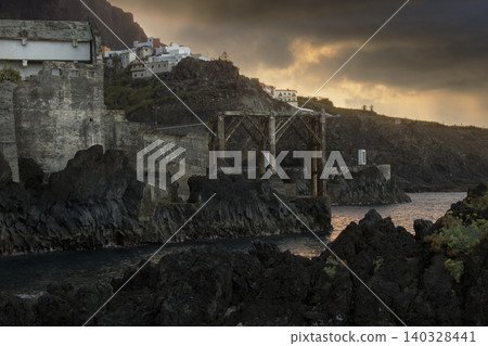 Historic ruins on volcanic coastline at sunset Historic ruins on volcanic coastline at sunset 140328441