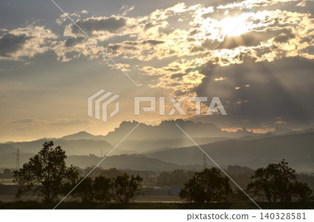 Montserrat mountain landscape with crepuscular rays at sunset Montserrat mountain landscape with crepuscular rays at sunset 140328581