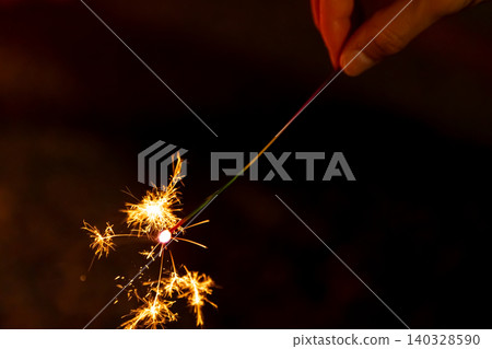 Sparklers branching out beautifully in the darkness of the night 140328590