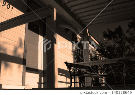 House porch bench bathing in warm afternoon light House porch bench bathing in warm afternoon light 140328649