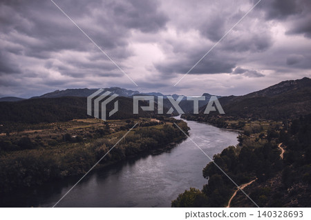 Curved river under a cloudy sky Curved river under a cloudy sky 140328693